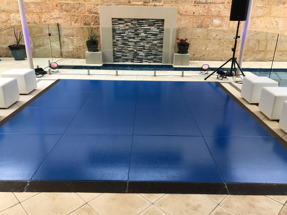 Blue gloss dance floor set up beside a pool