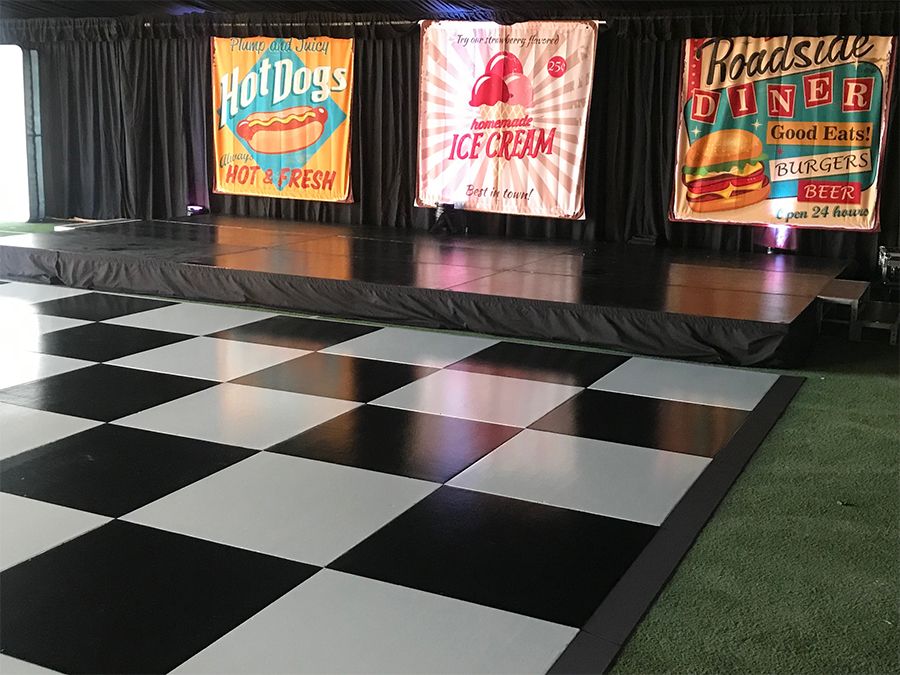 Black and white checkered dance floor in front of a stage
