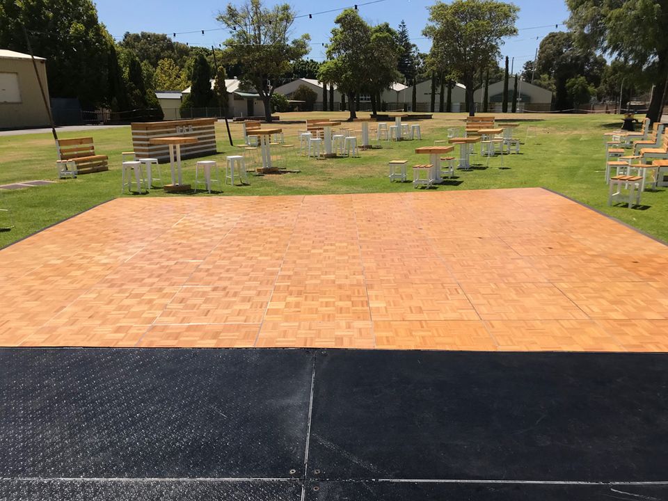 Parquetry dance floor set up on a garden lawn
