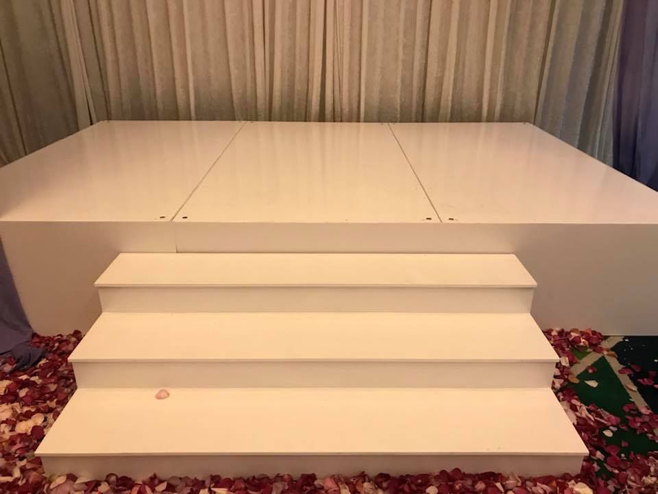 White stage with wide white steps in a function room