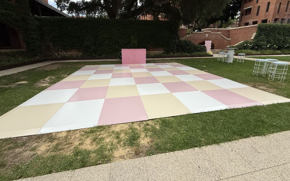 Pastel pink, lemon and white checkered dance floor on a courtyard lawn
