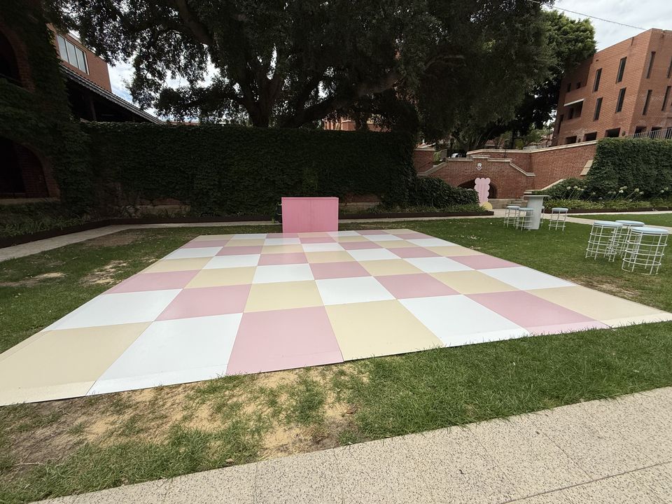 Pastel pink, lemon and white checkered dance floor on a courtyard lawn